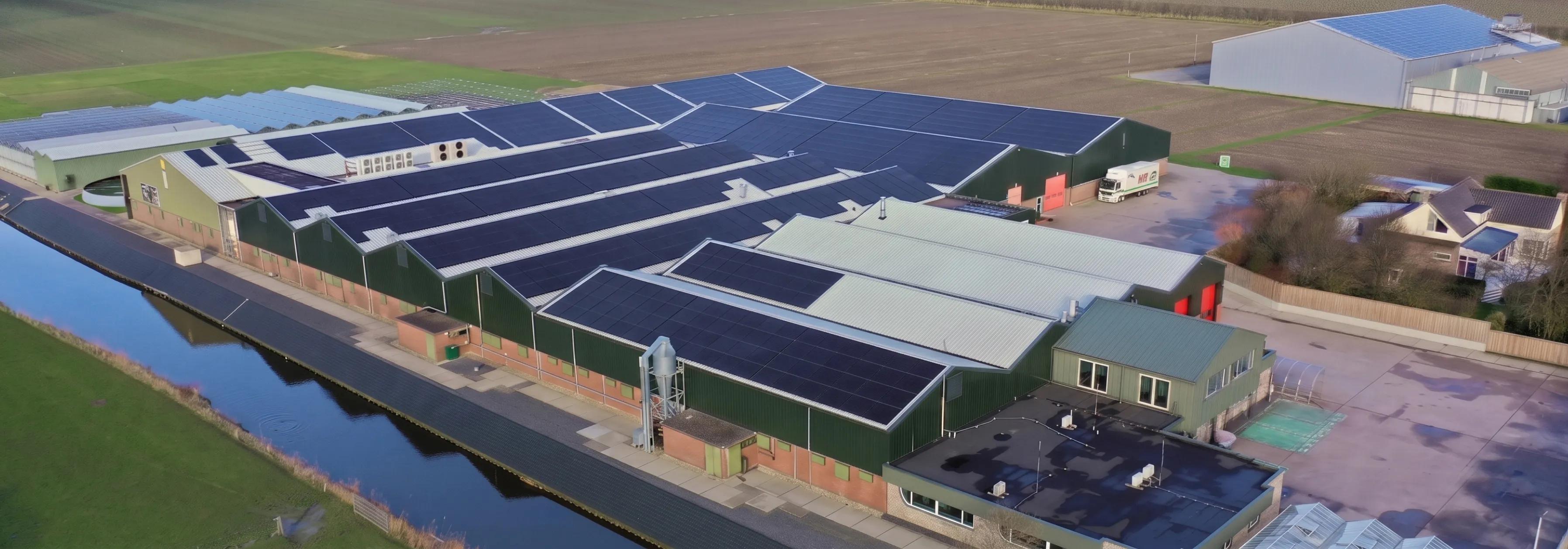A massive commercial solar panel array on an Alberta multi-unit residential building, demonstrating durability and performance in winter conditions.
