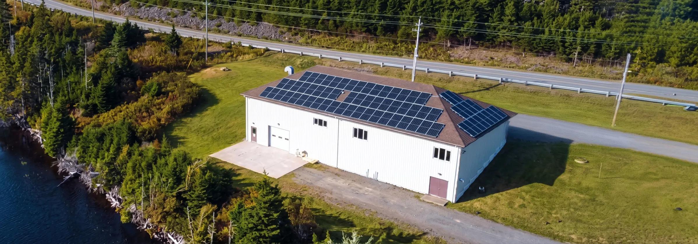 Commercial solar energy system on a flat-roofed PEI facility, highlighting the 30% Federal ITC and provincial business rebates for clean energy.