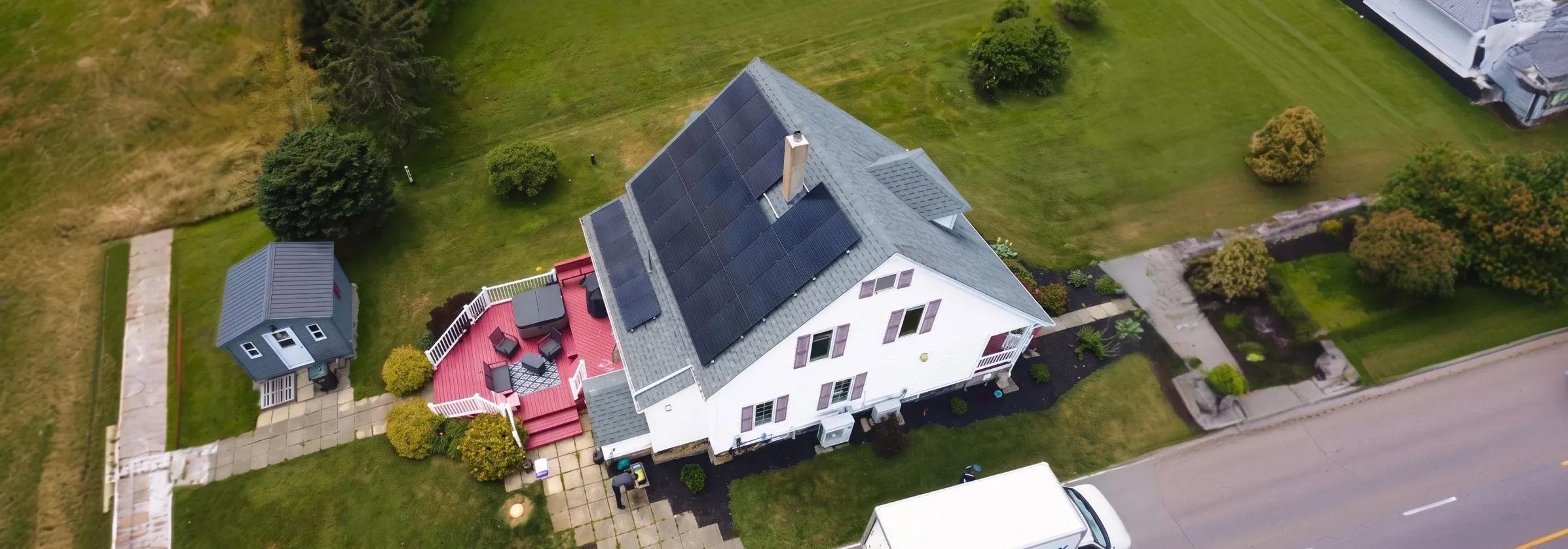 High-performance solar panels installed on a classic white Nova Scotia residential roof, harnessing the province's 2,000+ annual sun hours.