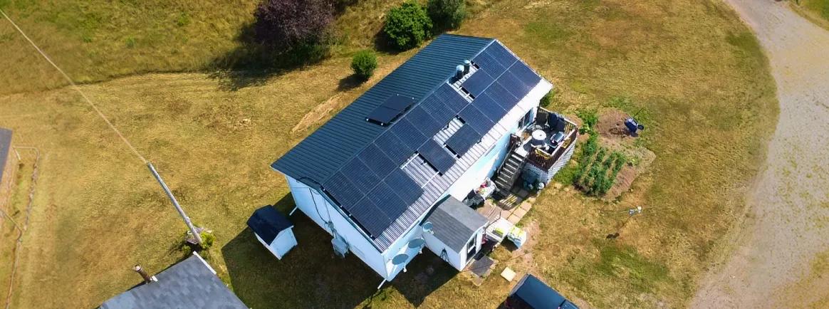 Aerial view of a sleek, high-efficiency solar energy system on a modern residential property in suburban Nova Scotia.