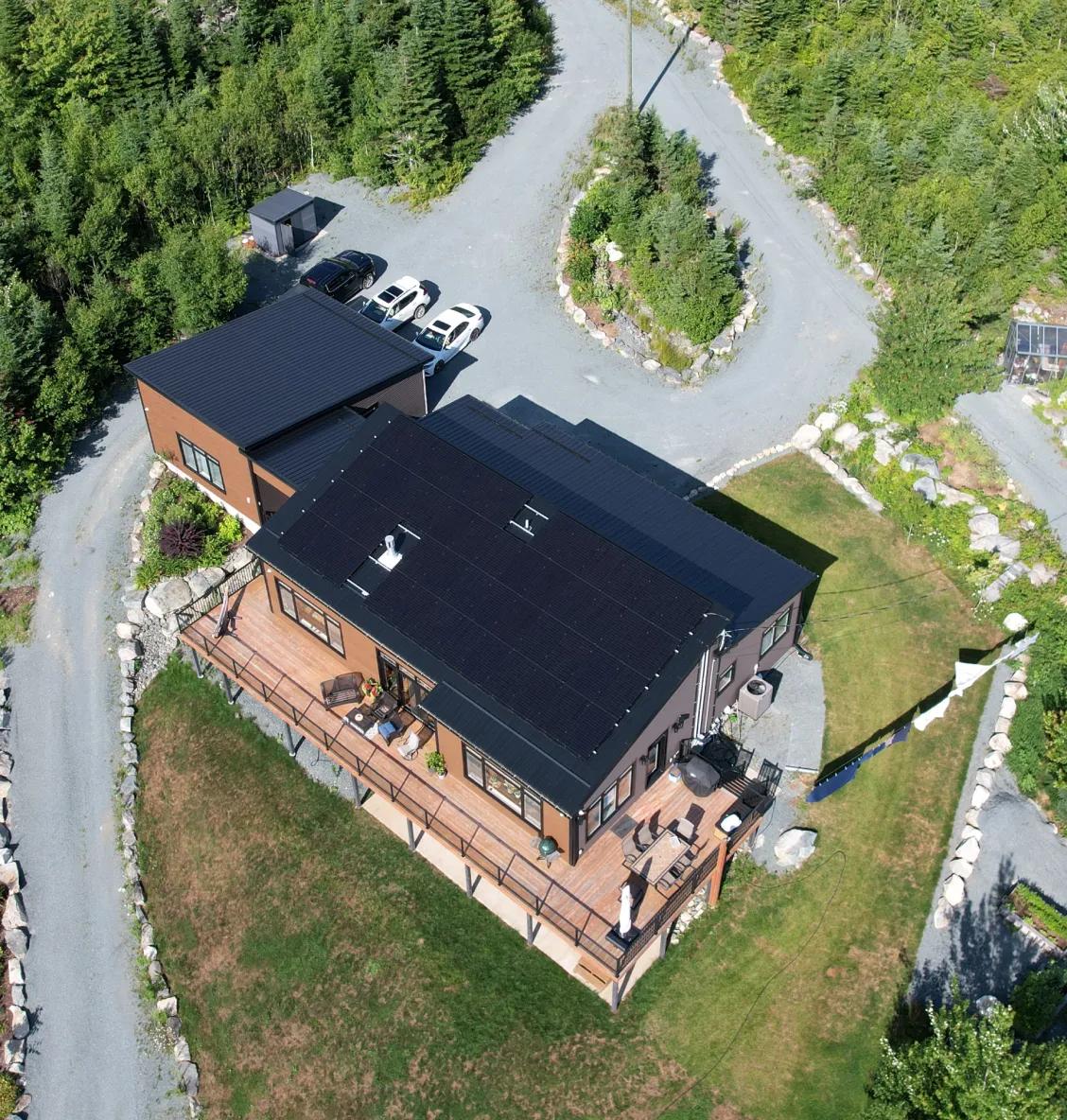 Modern coastal home in Nova Scotia featuring an integrated solar and battery storage system for storm resilience and energy independence.