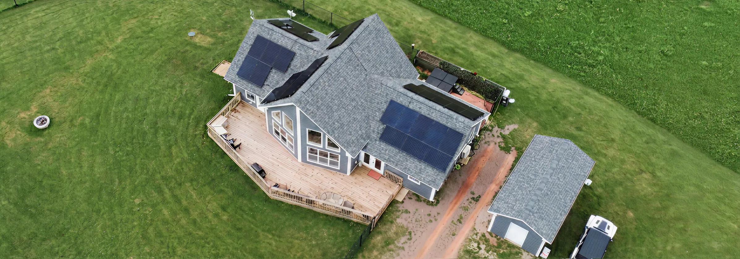 Large residential solar panel installation on a modern white PEI home, optimized for Maritime Electric net metering and maximum energy savings.