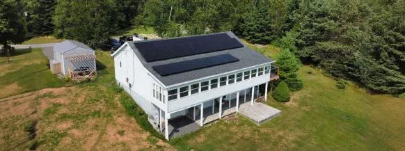 Professional residential solar installation on a large white industrial facility in New Brunswick, eligible new brunswick solar rebate.