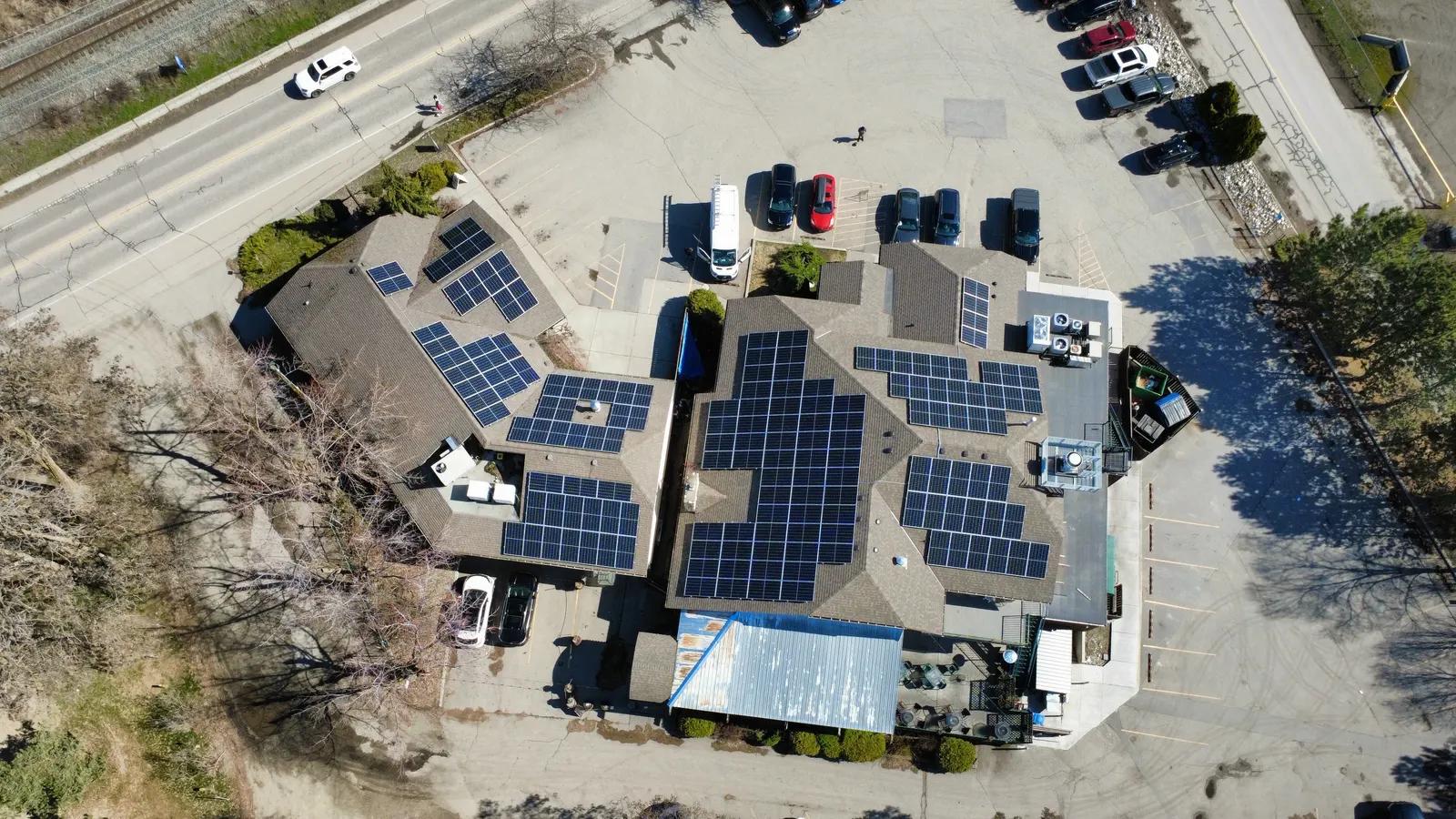 Aerial view of a commercial retail building with rooftop solar panels