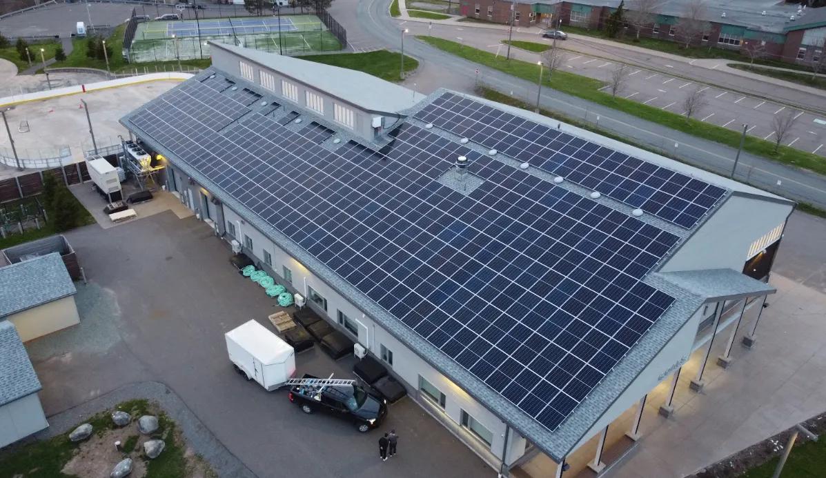 Aerial view of an institutional building with rooftop solar panels