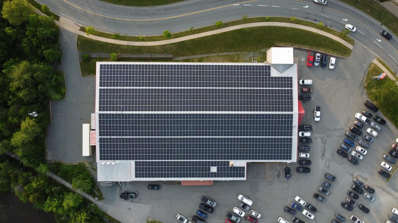 Aerial view of a community building with rooftop solar panels