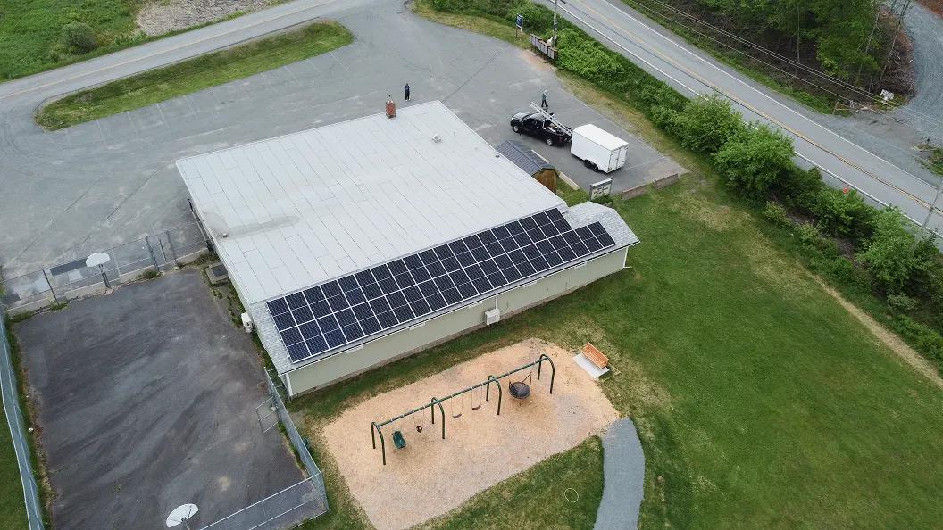 Large-scale commercial solar panel installation and battery energy storage system (BESS) on an Ontario school rooftop.