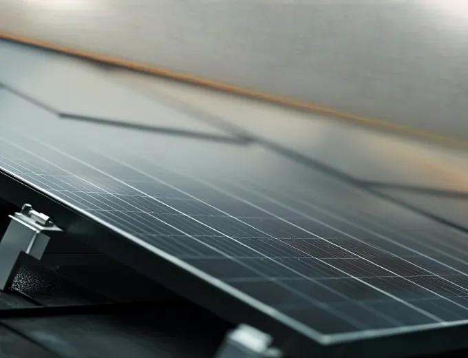 Detailed shot of a durable, weather-resistant Pion Power solar racking system anchoring panels to a residential roof.