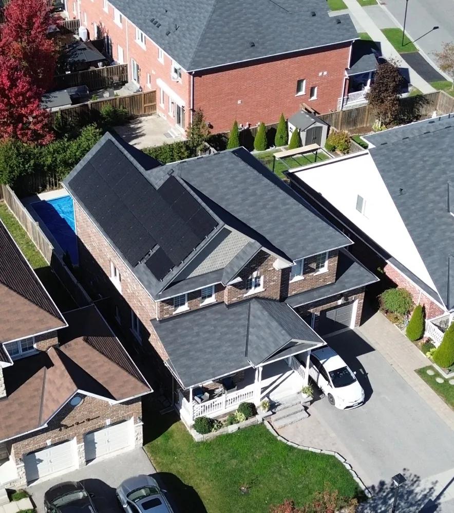 Bird's-eye view of a suburban residential property showcasing a complete turnkey home solar panel installation.